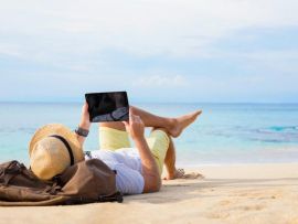 Man with tablet on the beach