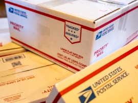 stack of USPS priority mail shipping boxes