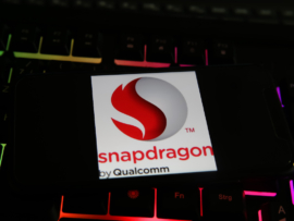 Closeup of smartphone with logo lettering of snapdragon qualcomm processor cpu on computer keyboard